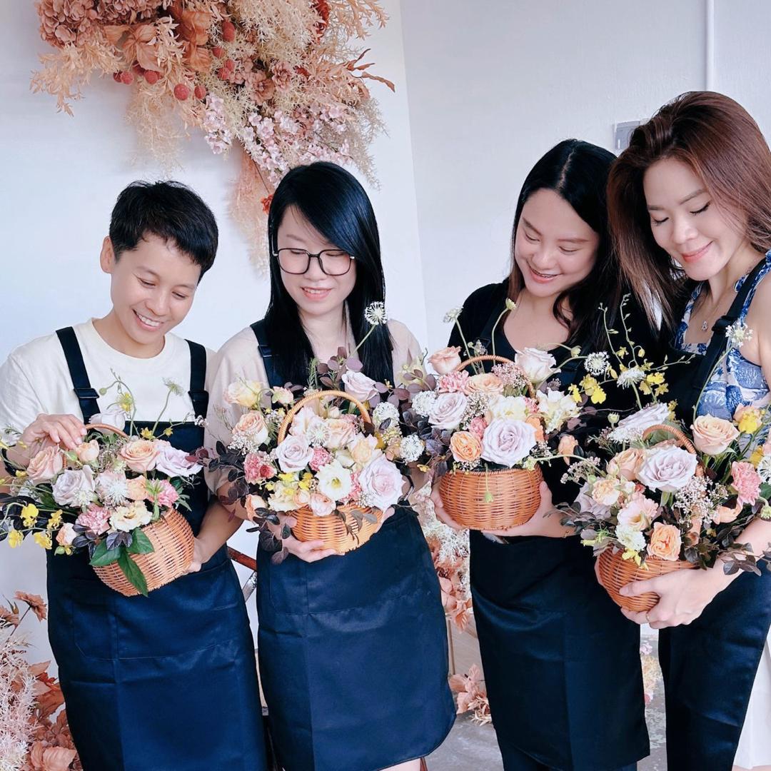apprentice florists holding their creations