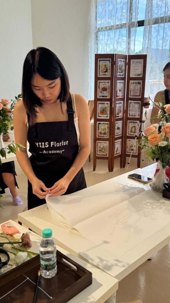 a florist learning how to make floral arrangement