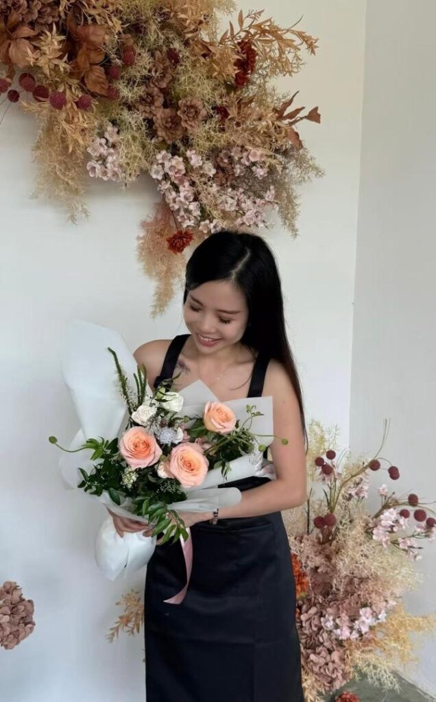 a florist looking at her creation happily