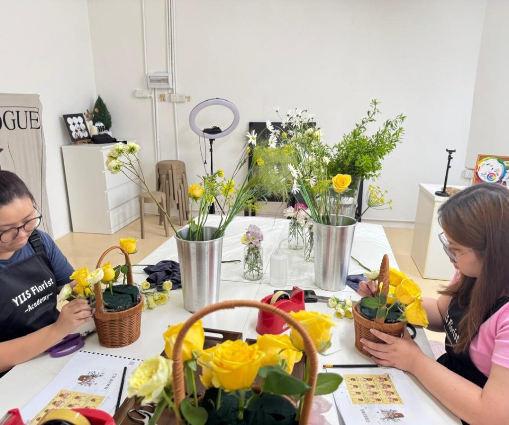 apprentices having hands on floral class training